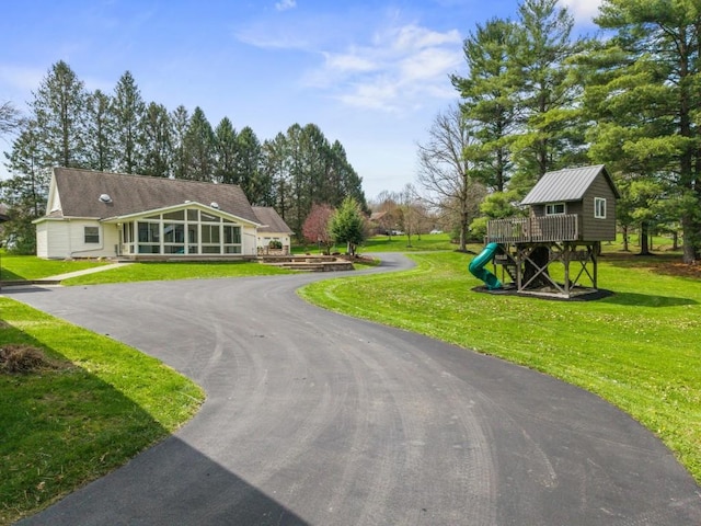 11350 State Highway 618, Conneaut Lake, PA 16316 - view of front of home featuring a playground, a sunroom, a front yard, and driveway