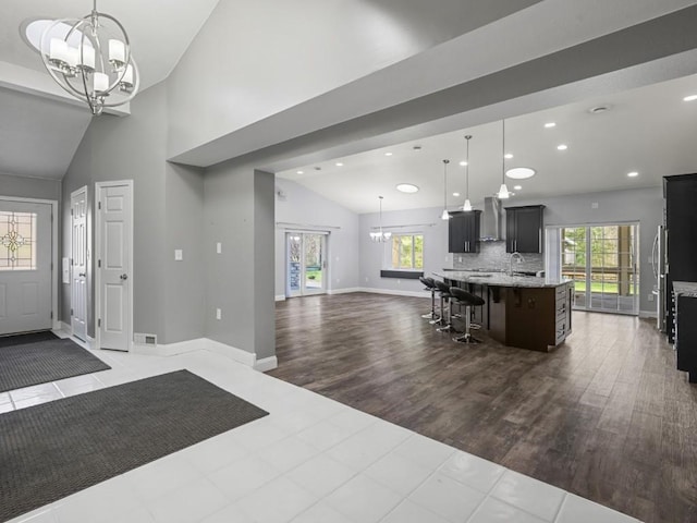 11350 State Highway 618, Conneaut Lake, PA 16316 - kitchen with a chandelier, open floor plan, vaulted ceiling, wall chimney exhaust hood, and plenty of natural light