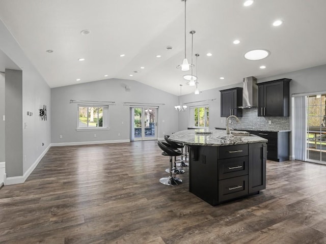 11350 State Highway 618, Conneaut Lake, PA 16316 - kitchen with wall chimney range hood, plenty of natural light, open floor plan, a center island with sink, and vaulted ceiling