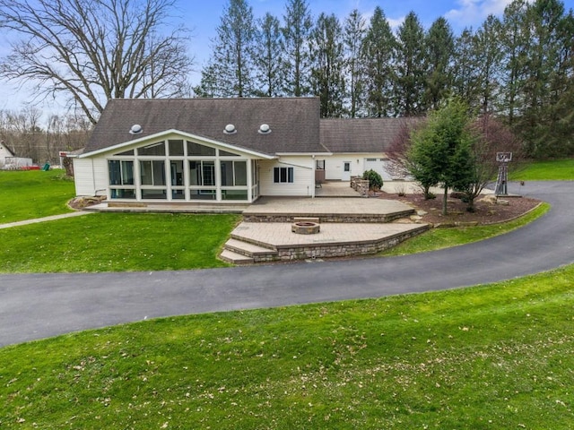11350 State Highway 618, Conneaut Lake, PA 16316 - back of property featuring a sunroom, a fire pit, a patio area, and a yard