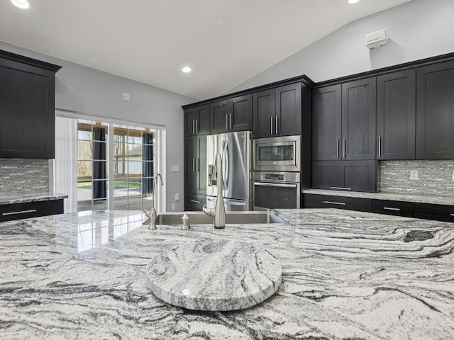 11350 State Highway 618, Conneaut Lake, PA 16316 - kitchen featuring appliances with stainless steel finishes, lofted ceiling, tasteful backsplash, recessed lighting, and light stone countertops