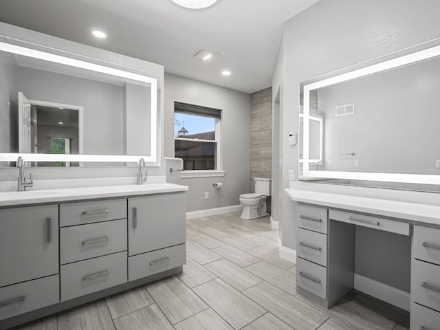 11350 State Highway 618, Conneaut Lake, PA 16316 - full bathroom featuring double vanity, toilet, baseboards, recessed lighting, and wood finish floors