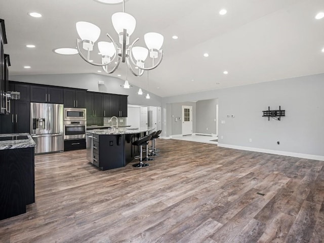 11350 State Highway 618, Conneaut Lake, PA 16316 - kitchen with appliances with stainless steel finishes, vaulted ceiling, a chandelier, dark cabinetry, and a breakfast bar area