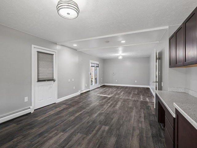 11350 State Highway 618, Conneaut Lake, PA 16316 - unfurnished living room with dark wood-style floors, a baseboard heating unit, baseboards, recessed lighting, and a textured ceiling