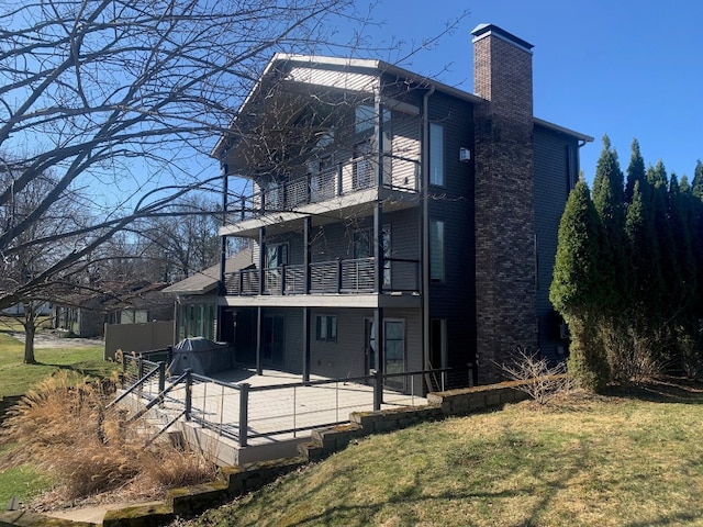 11148 Aldina Dr, Conneaut Lake, PA 16316 - back of house featuring a lawn, a patio, a chimney, and a balcony