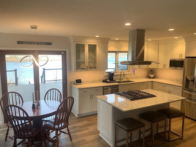11148 Aldina Dr, Conneaut Lake, PA 16316 - kitchen with a sink, appliances with stainless steel finishes, island range hood, and white cabinetry