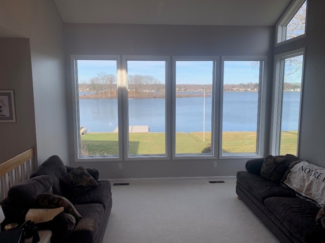 11148 Aldina Dr, Conneaut Lake, PA 16316 - carpeted living area with visible vents, a water view, and a healthy amount of sunlight