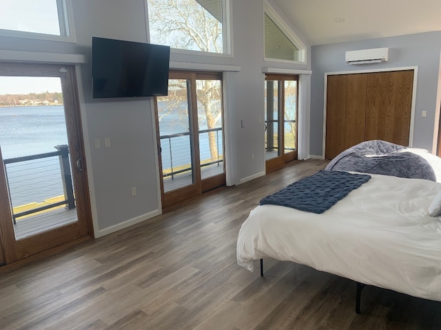 11148 Aldina Dr, Conneaut Lake, PA 16316 - bedroom featuring a wall unit AC, wood finished floors, baseboards, high vaulted ceiling, and access to exterior