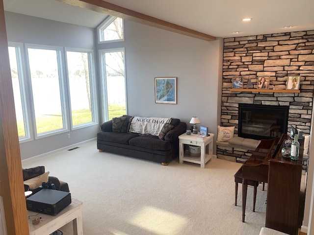 11148 Aldina Dr, Conneaut Lake, PA 16316 - living area with a wealth of natural light, carpet flooring, a stone fireplace, and lofted ceiling with beams