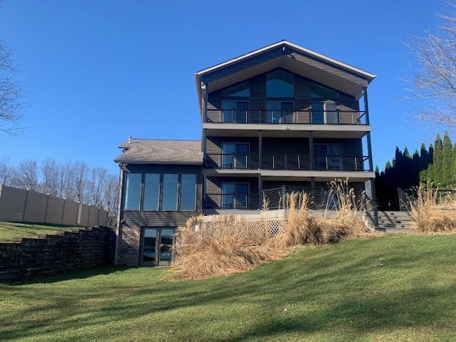 11148 Aldina Dr, Conneaut Lake, PA 16316 - back of property featuring a yard, a balcony, roof with shingles, and fence