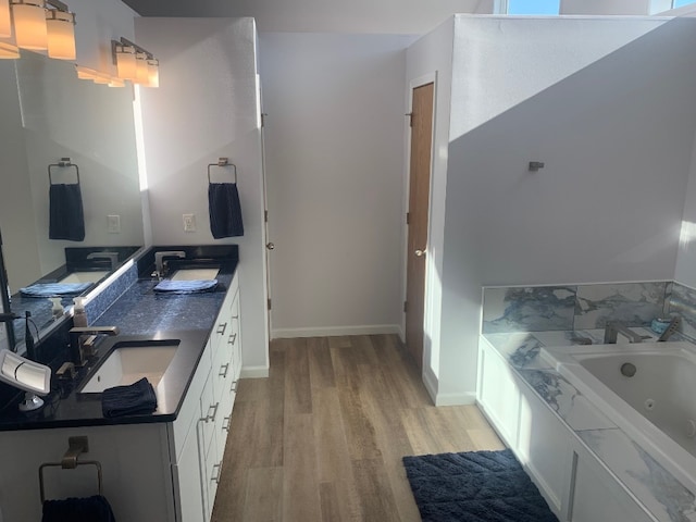 11148 Aldina Dr, Conneaut Lake, PA 16316 - bathroom with a sink, double vanity, wood finished floors, and a whirlpool tub