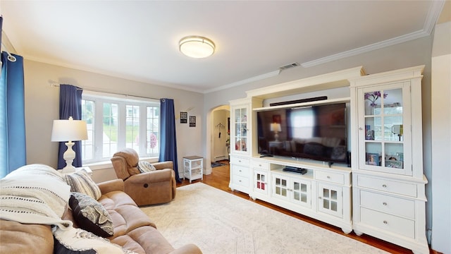 1450 Nicholson St, Erie, PA 16509 - living room featuring ornamental molding, wood finished floors, arched walkways, and a baseboard radiator