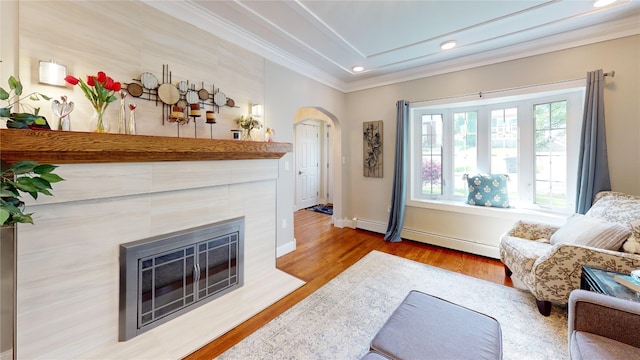 1450 Nicholson St, Erie, PA 16509 - living area with light wood finished floors, ornamental molding, arched walkways, baseboard heating, and a tiled fireplace