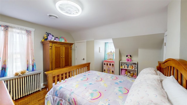1450 Nicholson St, Erie, PA 16509 - bedroom featuring radiator heating unit, multiple windows, and wood finished floors