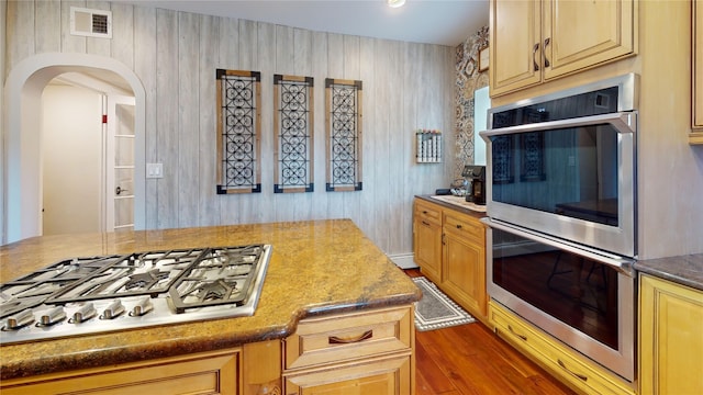 1450 Nicholson St, Erie, PA 16509 - kitchen featuring white gas cooktop, stainless steel double oven, arched walkways, and wood finished floors