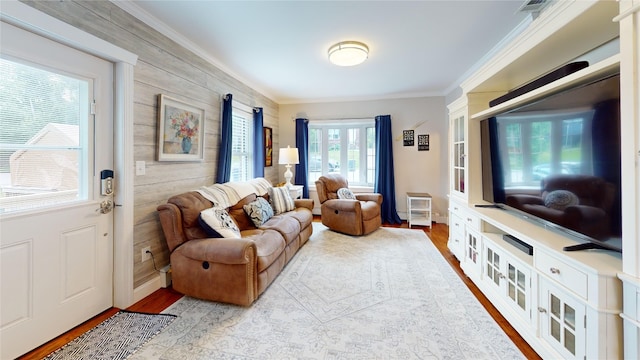 1450 Nicholson St, Erie, PA 16509 - living room featuring ornamental molding, wood finished floors, and wood walls