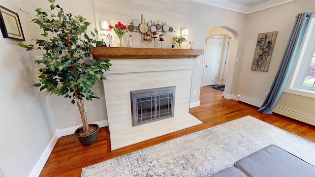 1450 Nicholson St, Erie, PA 16509 - living room featuring wood finished floors, arched walkways, crown molding, and a tile fireplace