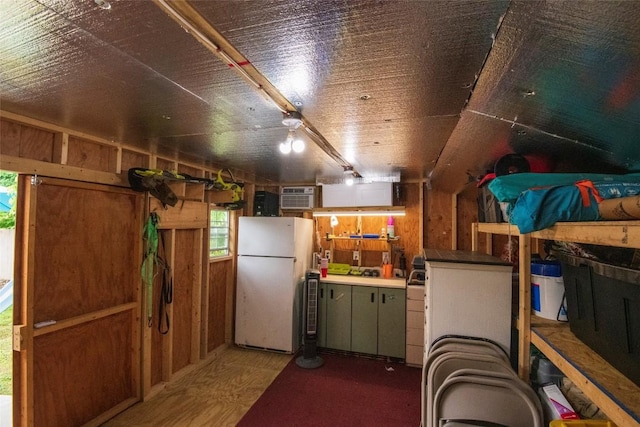 1450 Nicholson St, Erie, PA 16509 - basement featuring freestanding refrigerator, wooden walls, and a wall unit AC
