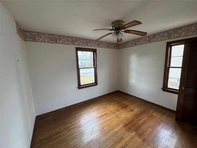 unfurnished room featuring ceiling fan, baseboards, and hardwood / wood-style flooring