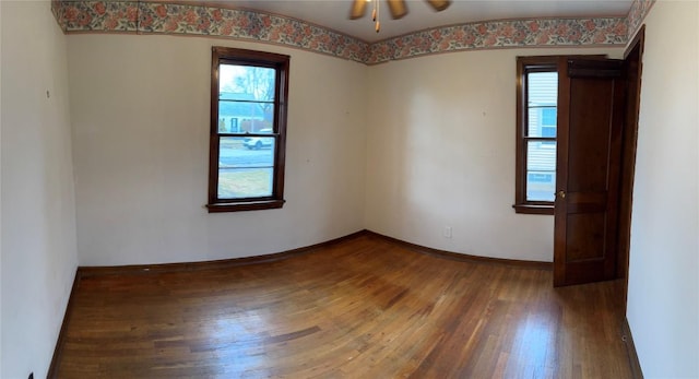 unfurnished room featuring hardwood / wood-style flooring, ceiling fan, and baseboards