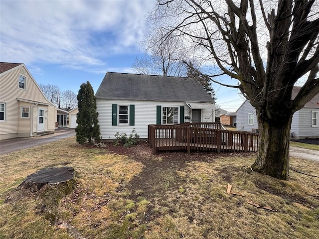 rear view of property featuring a deck