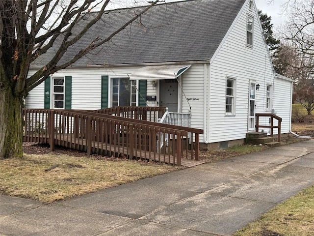 new england style home with a shingled roof