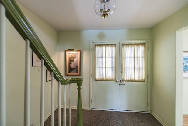 doorway to outside with carpet flooring