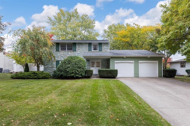 view of front of house with a front lawn, a garage, and central air condition unit