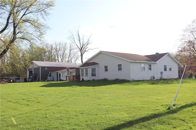 rear view of house featuring a lawn