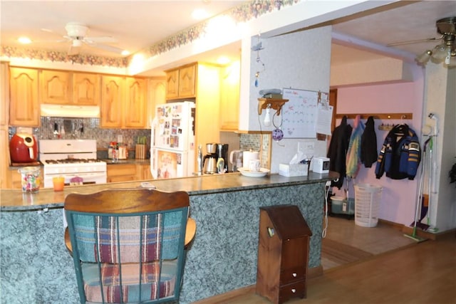 kitchen with ceiling fan, light brown cabinets, tasteful backsplash, white appliances, and hardwood / wood-style flooring