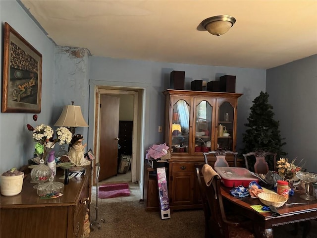 dining area featuring dark colored carpet