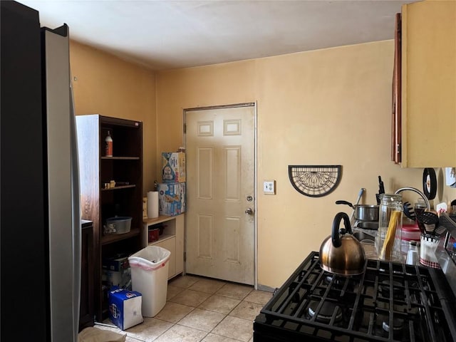 kitchen with range with gas stovetop and light tile patterned flooring