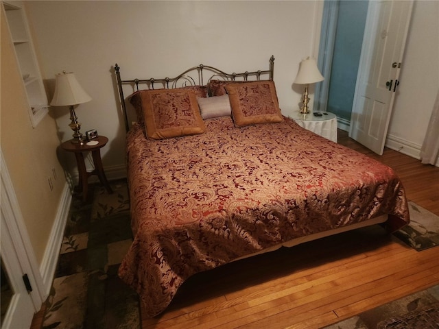 bedroom with wood-type flooring