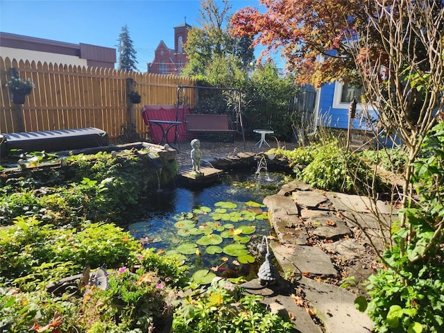 view of yard with a small pond