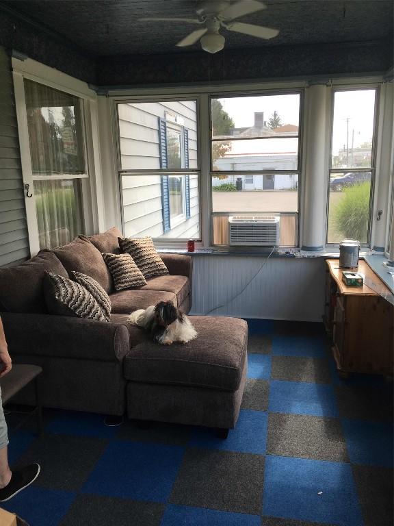 sunroom / solarium featuring ceiling fan and cooling unit