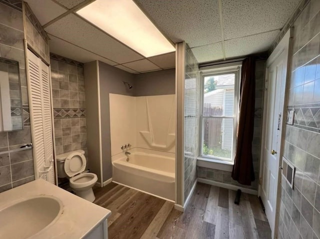 1121 E 27th St, Erie, PA 16504 - full bath featuring a paneled ceiling, tile walls, toilet, wood finished floors, and vanity