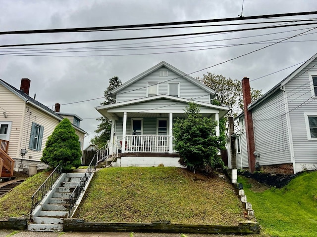 1121 E 27th St, Erie, PA 16504 - view of front of property featuring stairs, covered porch, and a front lawn