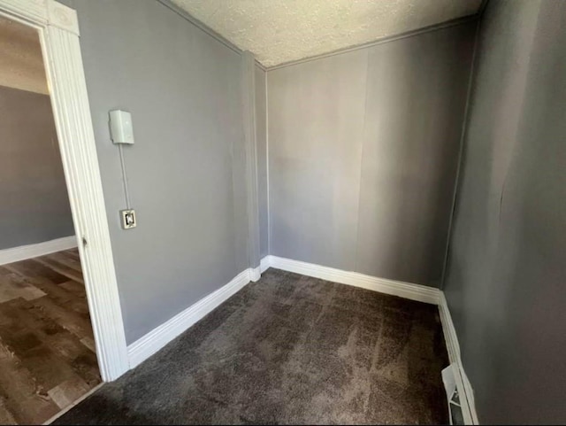 1121 E 27th St, Erie, PA 16504 - spare room featuring a textured ceiling, baseboards, and dark carpet