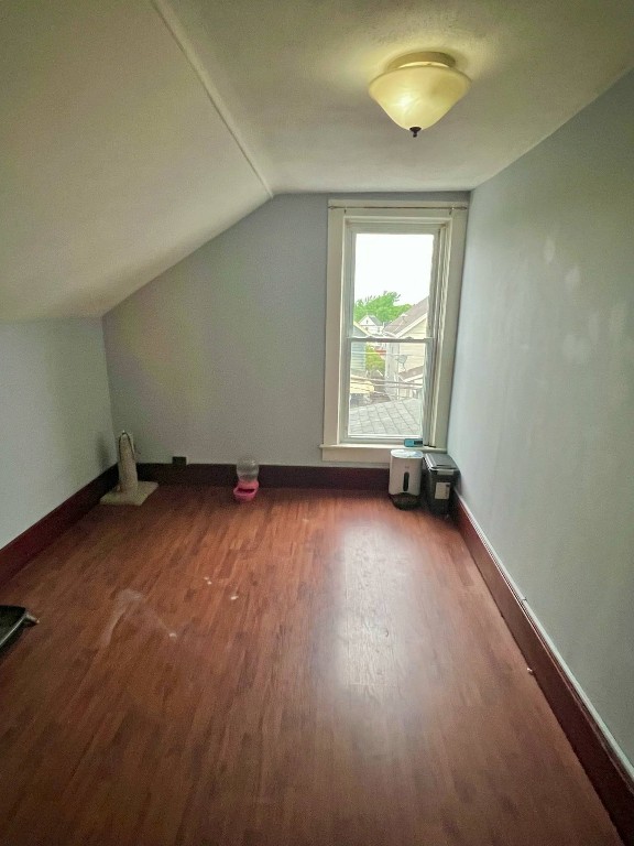 1121 E 27th St, Erie, PA 16504 - bonus room featuring wood finished floors, lofted ceiling, and baseboards