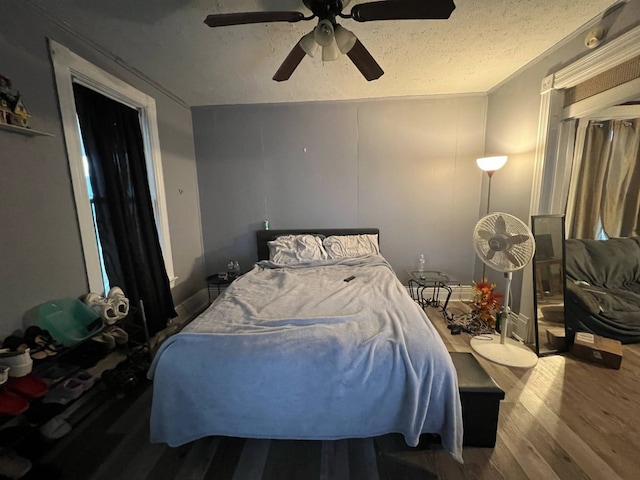 1121 E 27th St, Erie, PA 16504 - bedroom with wood finished floors, a ceiling fan, lofted ceiling, and a textured ceiling