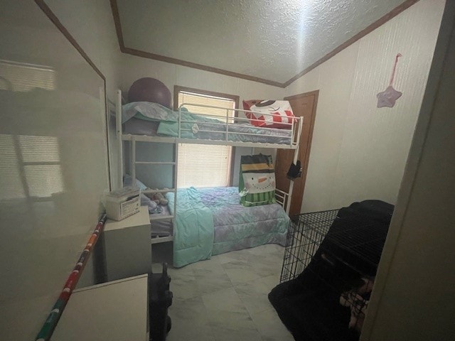 bedroom featuring a textured ceiling and crown molding