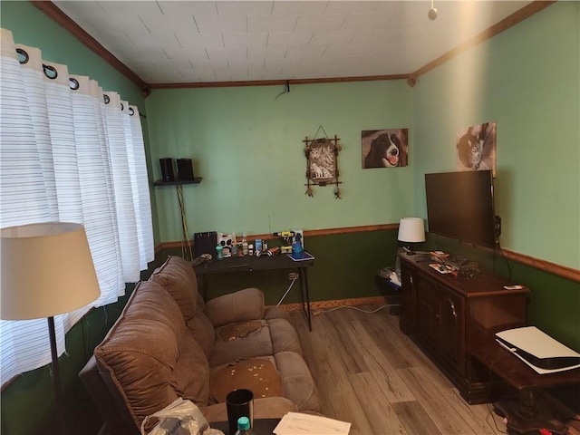 living room with light hardwood / wood-style floors and ornamental molding