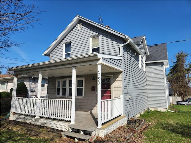 bungalow-style house featuring covered porch and a front lawn