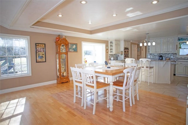 dining area featuring light hardwood / wood-style flooring and crown molding