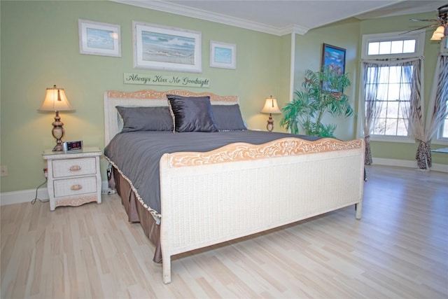 bedroom with light hardwood / wood-style flooring, ceiling fan, and ornamental molding