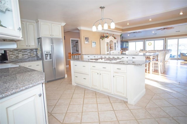 kitchen with stainless steel fridge, ceiling fan, decorative light fixtures, white cabinets, and light tile patterned flooring