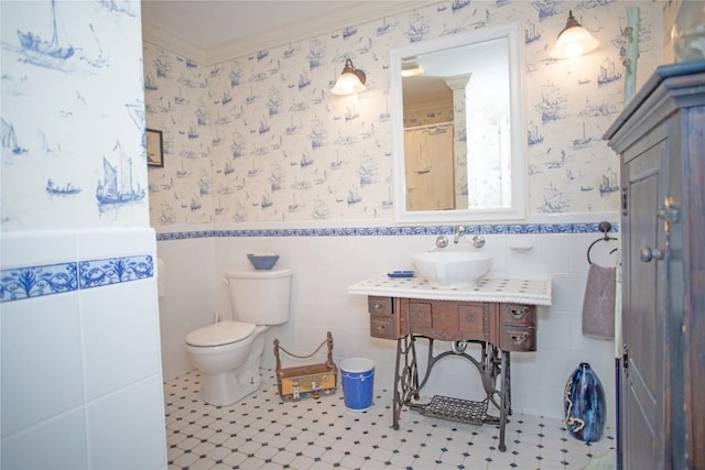 bathroom with tile patterned floors, crown molding, vanity, and toilet