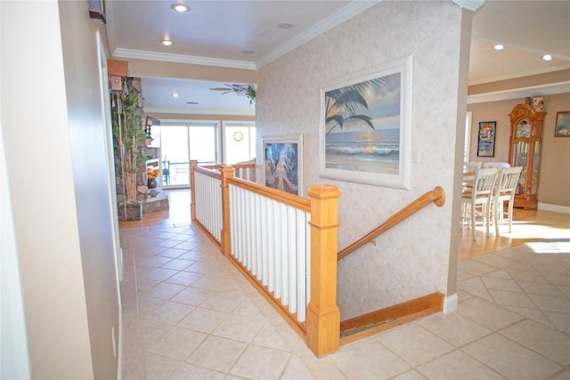 hallway with crown molding and light tile patterned floors