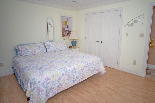 bedroom featuring hardwood / wood-style flooring, a closet, and crown molding