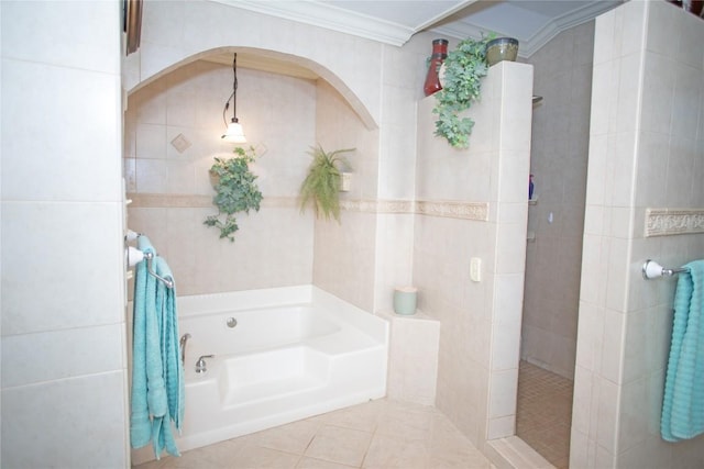 bathroom with tile patterned floors, crown molding, tile walls, and independent shower and bath